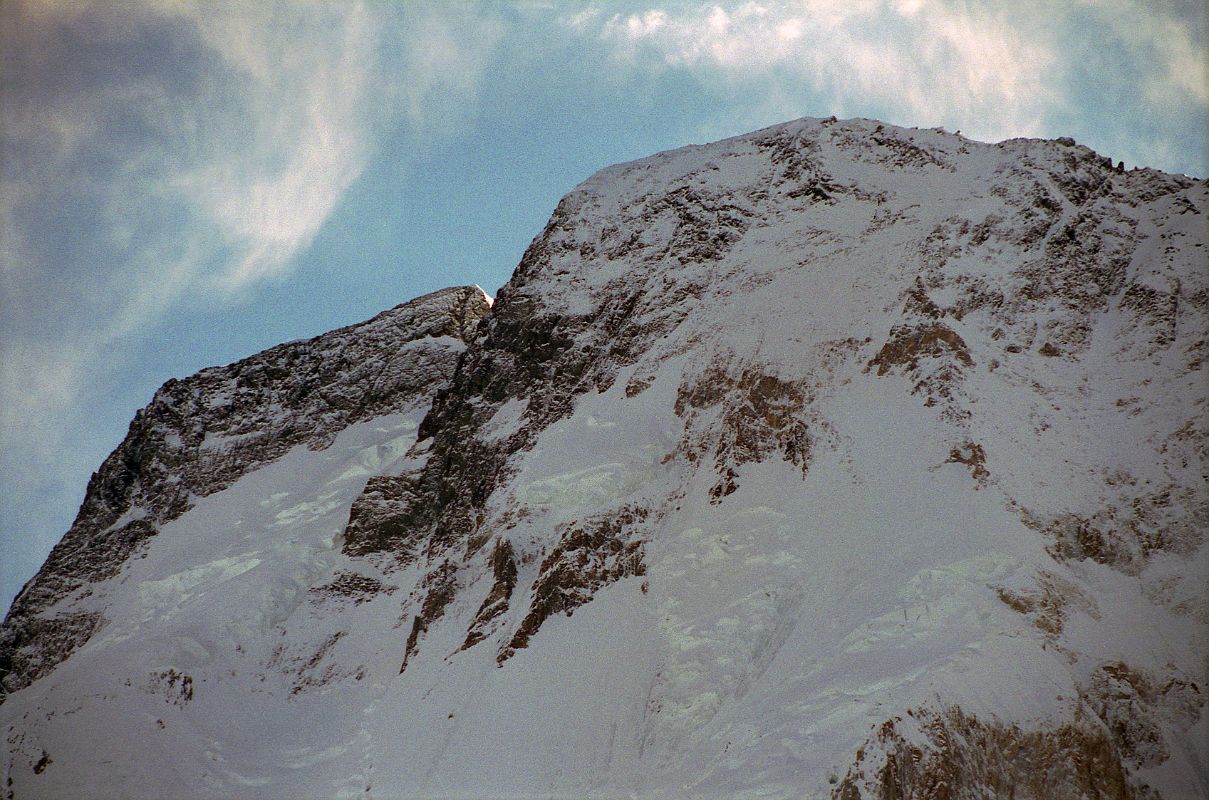 31 Broad Peak Central Summit And Main Summit Just After Sunrise From Concordia Here is a close up of the Broad Peak Central Summit and the Broad Peak Main Summit just after sunrise from Concordia. The first ascent of the Broad Peak Central or Middle summit was completed by Poles Kazimierz Glazek and Janusz Kulis on July 28, 1975 while three other members huddled 40m away and a few metres lower. During the descent the weather worsened. Bohdan Nowaczyk was killed when the rope anchor failed. Andrzej Sikorski slipped, knocking Marek Kesicki and Kulis off. Only Kulis survived the fall. Kulis and Glazek eventually made it back to the expedition's top camp. Both were frostbitten, Kulis subsequently losing most of his toes